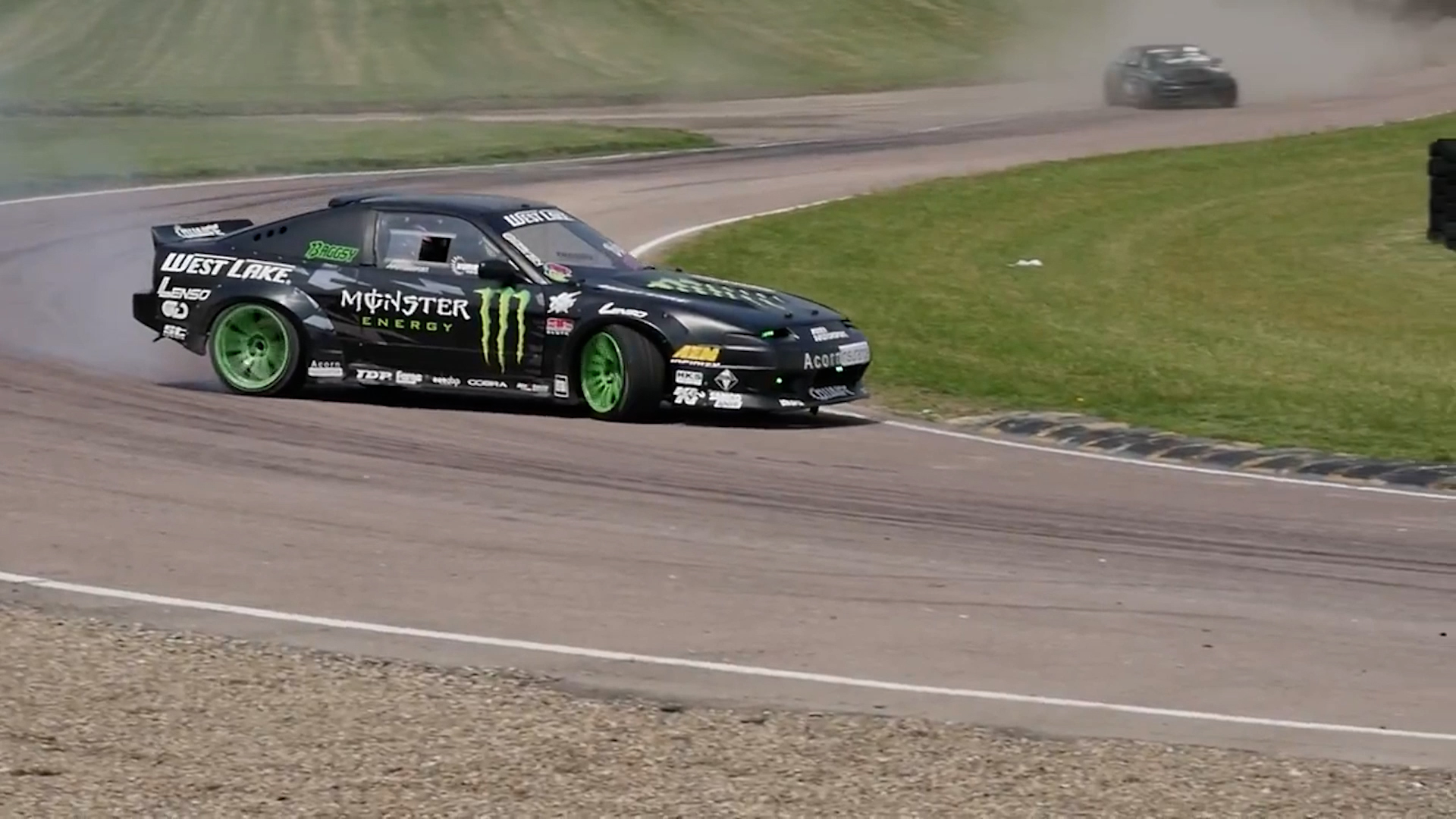 A touring car at speed on a racetrack